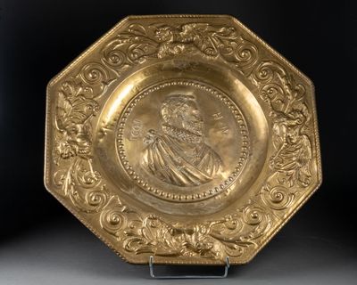 an image of a gold plate with a portrait of a man on it