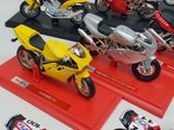 many different models of motorcycles on display on a table