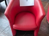 two red chairs with a sign on them in a room