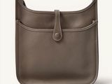 a close up of a brown leather purse on a white background