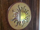 a wooden door with a decorative mirror on it