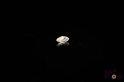 a close up of a diamond in the dark with a black background