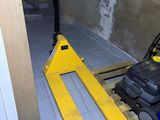 a forklift sitting in the middle of a room next to a wall