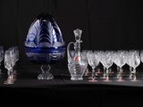 bottles and glasses are lined up on a table with a black background