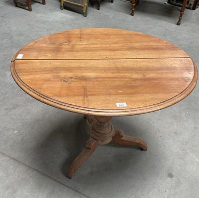 a wooden table with a round top and a wooden base
