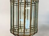 an antique brass and glass lantern hanging from the ceiling