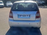 a small white car parked in a parking lot
