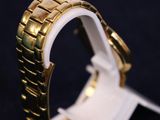 a close up of a watch on a stand on a black surface
