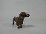 a small brown dog figurine on a white surface