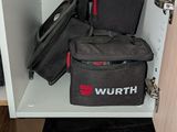 a small cabinet with a bunch of bags on top of it