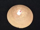 a picture of a wooden ball with a red dot on it