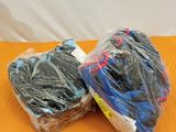 deux pelotes de laine emballées dans du plastique, posées sur une surface orange