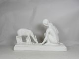 statue of a woman and a dog on a white marble base
