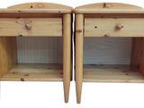 pair of wooden nightstands with drawers on each side of them