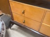 a wooden dresser with two drawers and a black top