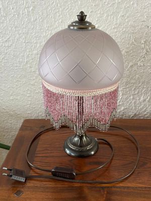 a lamp that is sitting on a table with a cord