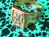 a close up of a ring on a green and black surface