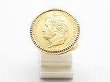 an image of a gold coin sitting on top of a white stand