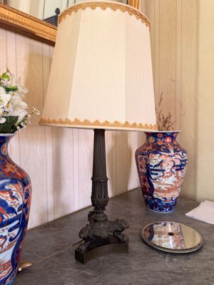 two vases and a lamp on a table in a room