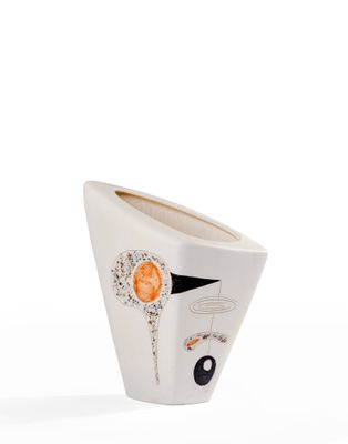 a white vase with a face on it on a white surface