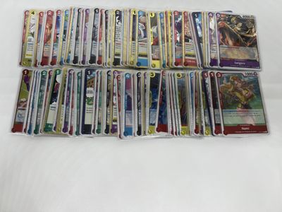a pile of pokemon cards sitting on top of a white table