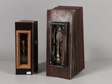 a small wooden box with a statue inside of it