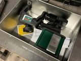 a metal box filled with assorted items on a table