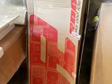 a cardboard box sitting on top of a desk next to a chair