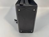 the back of a black purse on a white surface