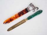 pair of knifes and a knife holder on a white surface