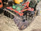 a tractor with a plow attached to it in the dirt
