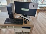 a desktop computer sitting on a desk with a keyboard and mouse