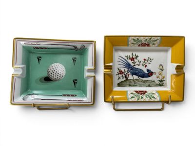 two ashtrays with a bird and a golf ball on them