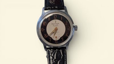 a watch that is sitting on a white surface