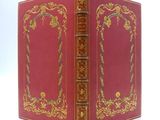 a red book with gold trim and a gold border
