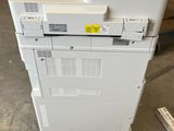 two printers are stacked on top of each other in a warehouse