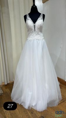 a white dress on a mannequin display in a room