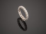 a white gold and diamond ring on a reflective surface