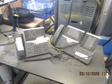 two telephones sitting on a table in a room