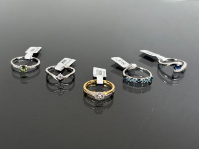 several different colored rings are arranged on a black surface