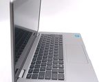 a silver laptop computer sitting on top of a white table