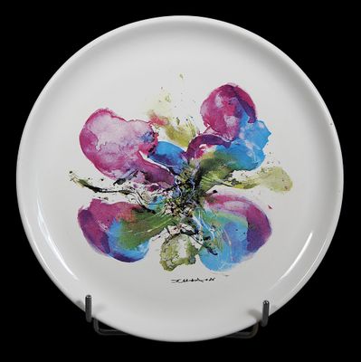 a white plate with a painting of a flower on it