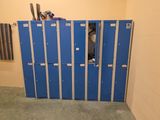 un casier bleu dans une petite pièce où se trouvent de nombreux casiers