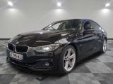 a picture of a black bmw car in a showroom