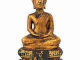 an image of a statue of a person sitting on a pile of books