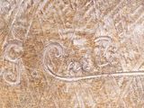 a close up of a carving of a bear on a piece of wood