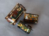 three toy tanks sitting on a table next to each other