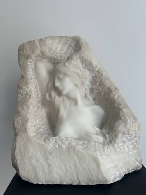 a sculpture of a dog in a rock on a table