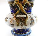 a blue and white vase that has a snake on it