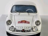a white car that is parked in a room